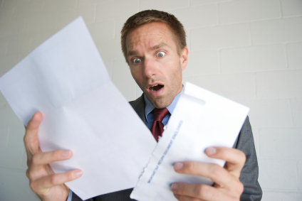 Confused business owner taking a look at his business' financial records